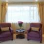 Master Suite Seating Area with Silk Curtains and Contemporary Fine Art