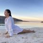 Fabi upward dog on the beach