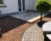 Modern-porcelain-patio-framed-by-cobble-lock-and-gravel