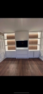 bespoke media wall combining slatted acoustic panelling and shaker-style cabinetry in Ratoath