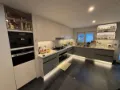 Tall oven housing and lit open shelving in a kitchen fitted in Dublin